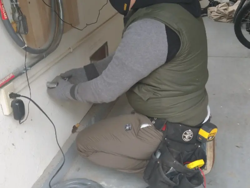 Electrician performing outlet wiring in a Cornwall garage